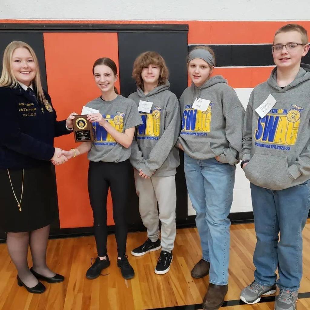 FFA QuizBowl team accepting second place plaque