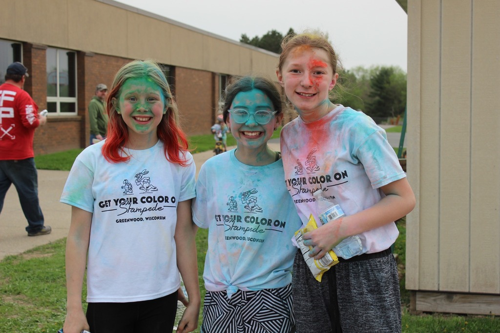 three girls covered in color